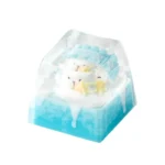 Handcrafted resin Ice World keycap featuring a whimsical miniature ice world diorama with a cute, playful cartoon penguin encased in clear resin.