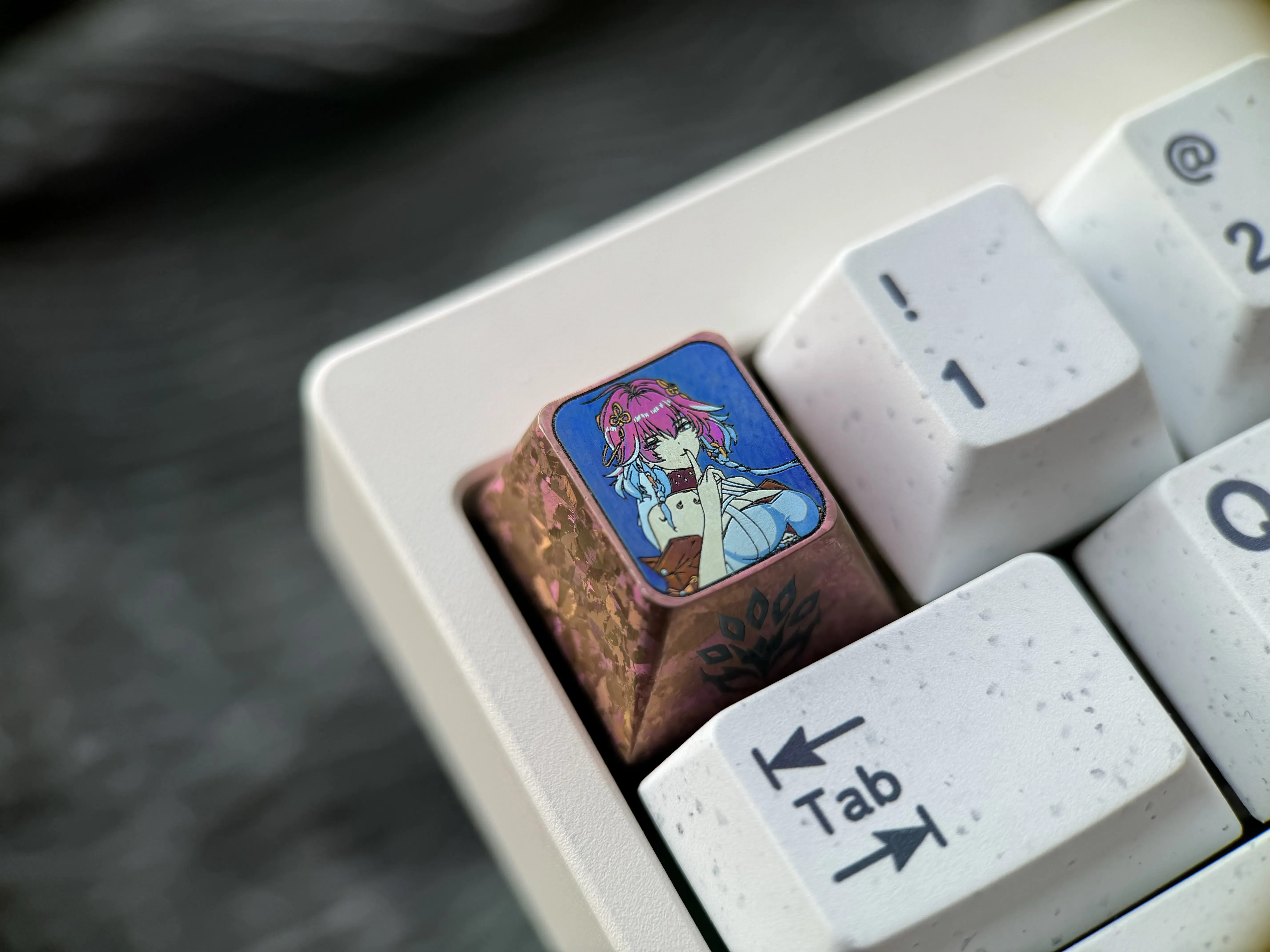 Detailed gallery views of the Wuthering Waves: Changli Titanium Keycap, highlighting its intricate fantasy patterns and premium polished titanium setup.