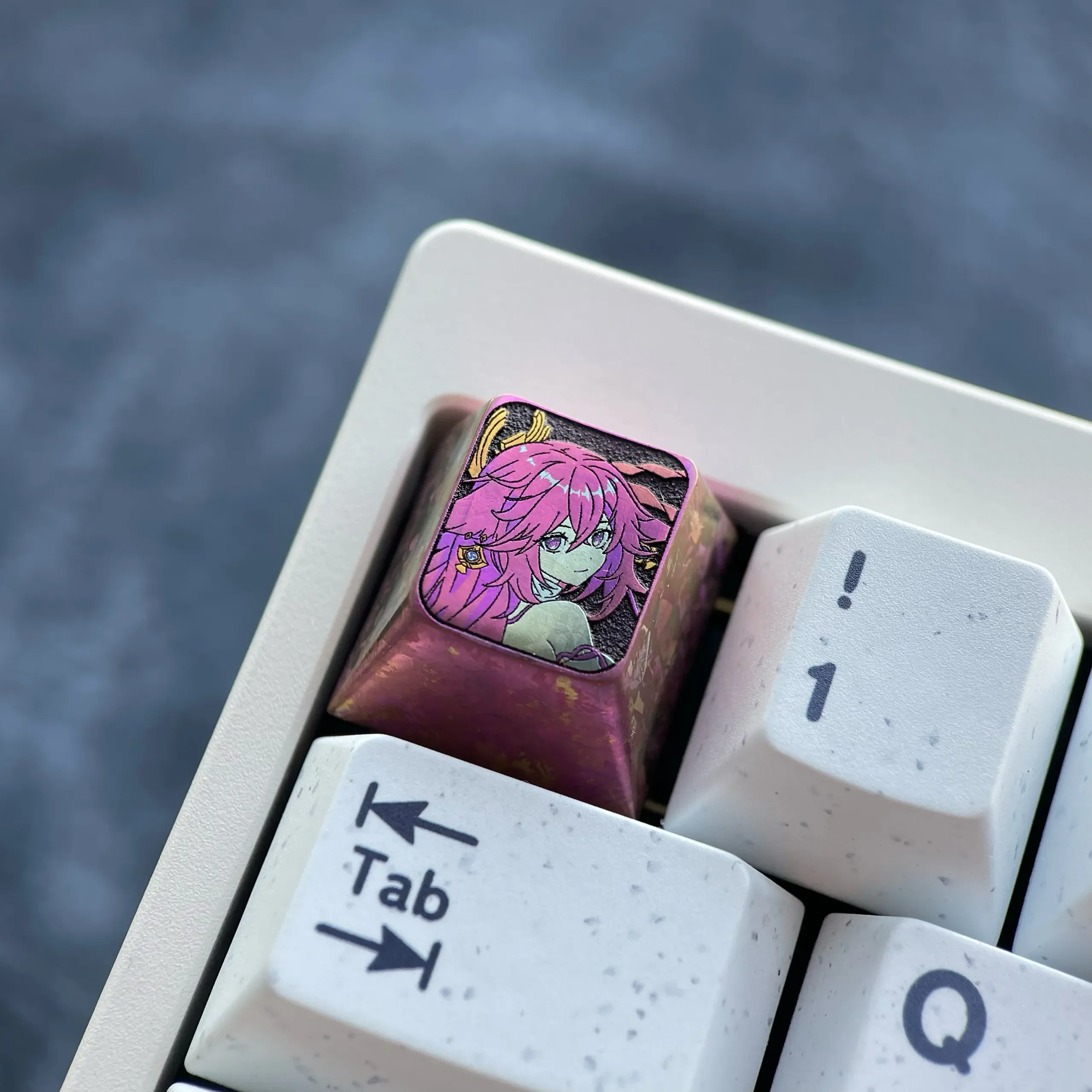 Exquisite anodized titanium Yae Miko keycap, presented from a captivating side angle, highlighting the mystical red finish and crystalline shimmer.