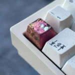 Exquisite anodized titanium Yae Miko keycap gallery. Capturing its mystical red shimmer and divine elegance from multiple angles for custom purpose.