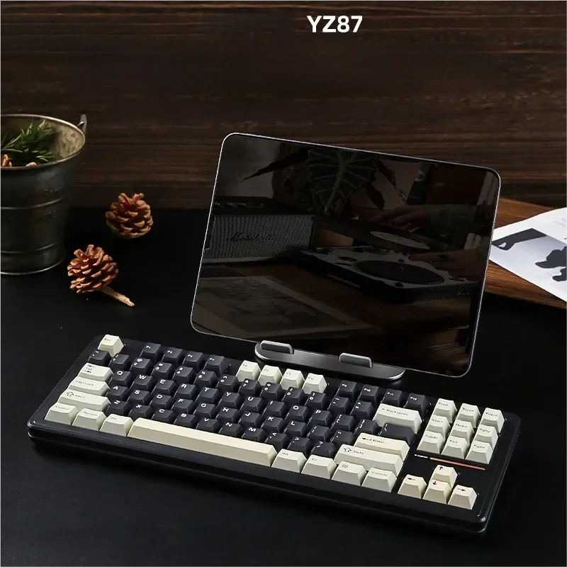 Striking YZ87 Black Hole custom mechanical keyboard. Gasket mount, hot-swappable, tri-mode, sleek black design with vibrant cosmic RGB.