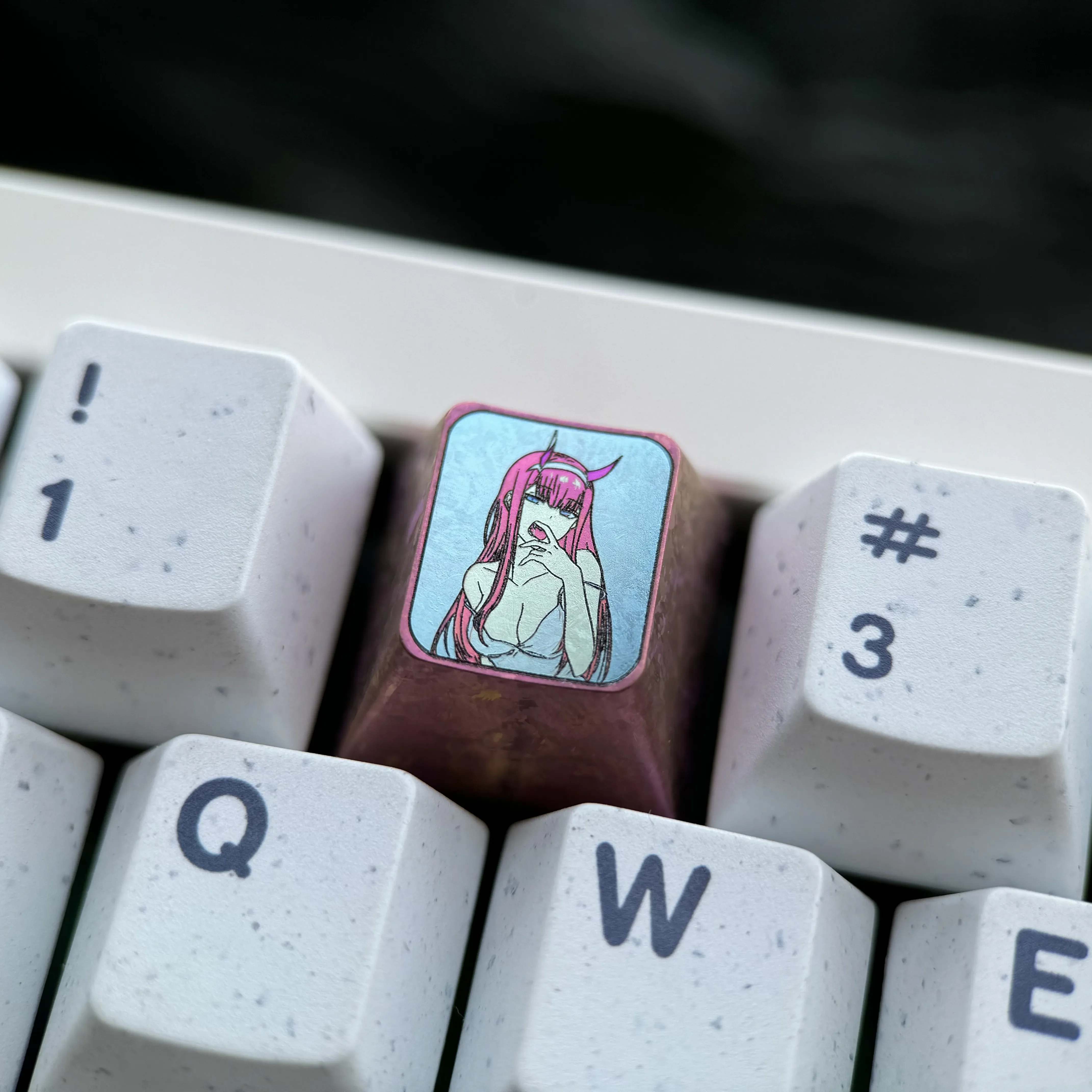 Iconic Zero Two keycap crafted from premium titanium, a vibrant custom anime keycap for enthusiasts of mechanical keyboards.