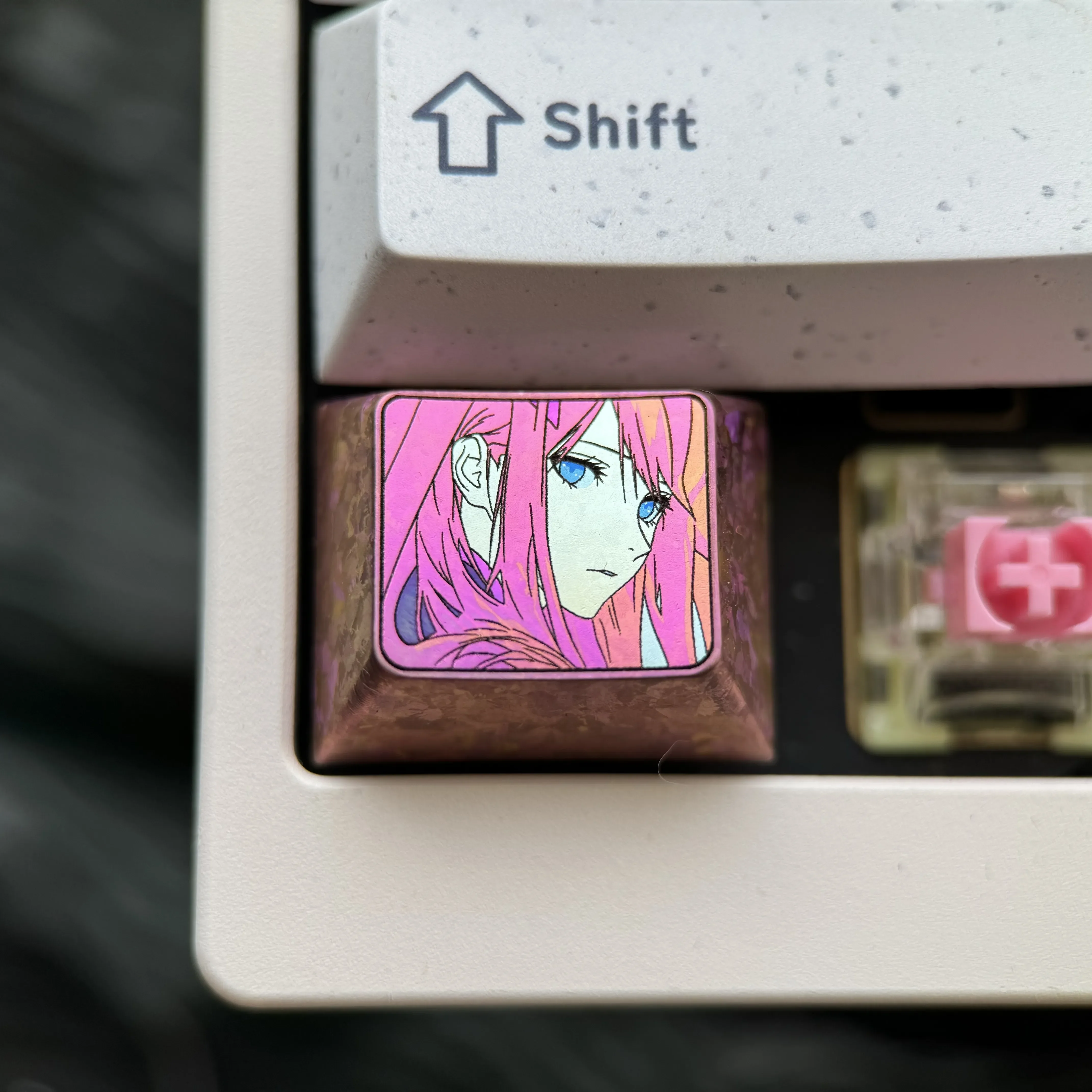 Vibrant Zero Two Titanium Keycap for mechanical keyboards, showcasing iconic anime colors on polished, durable alloy with a sleek design.