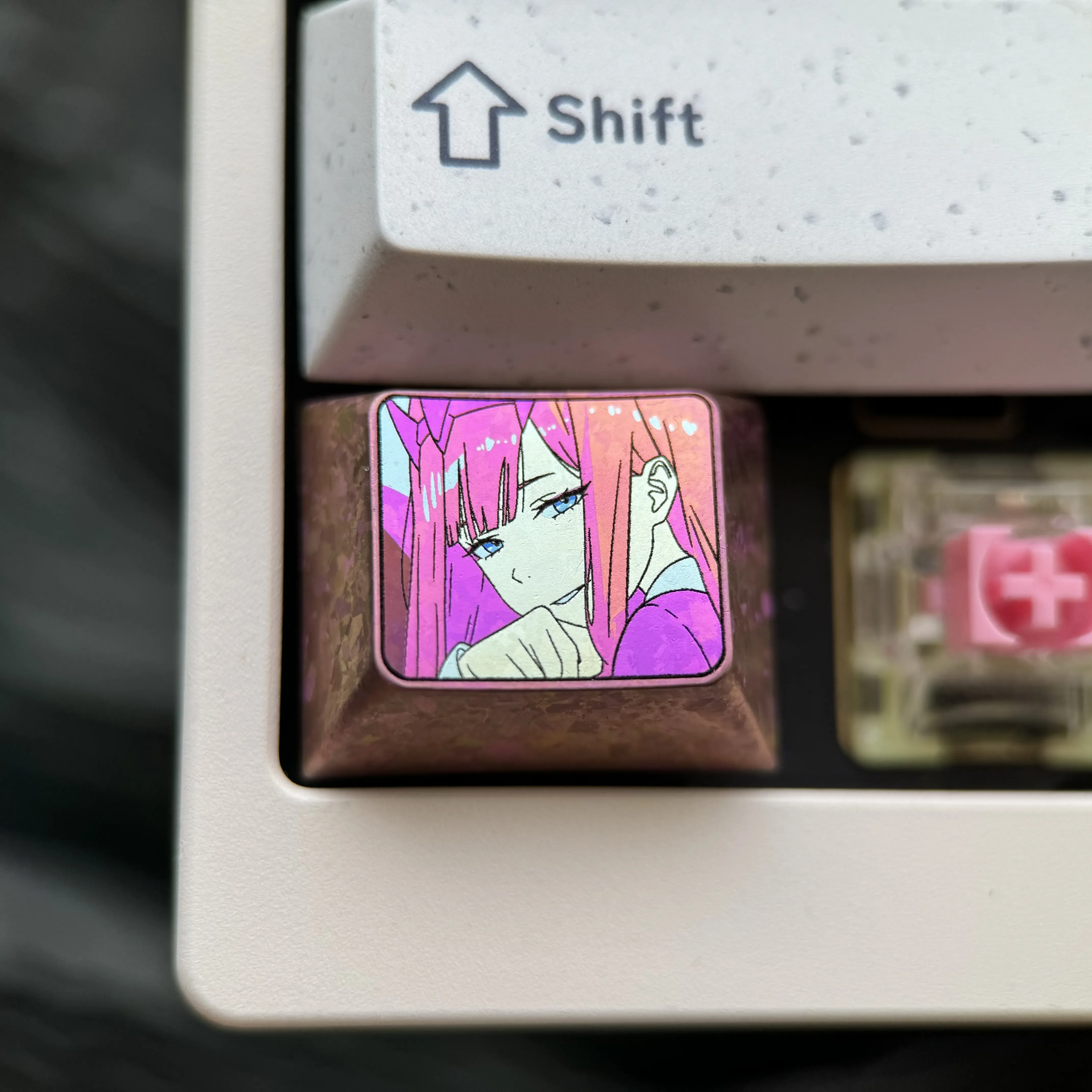 This vibrant, durable Zero Two titanium keycap features iconic anime colors and a sleek, polished finish for custom mechanical keyboards.