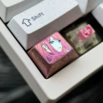 Vibrant Zero Two Titanium Keycap gallery showcasing its durable polished alloy, sleek anime-inspired design, and iconic colors from multiple premium setup.