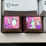 Vibrant Zero Two titanium keycap showcasing iconic anime colors on polished alloy for a durable, sleek custom keyboard accessory.