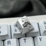 Premium 2B Titanium Keycap, a precision-engraved Nier Automata artisan masterpiece showcasing iconic 2B with a metallic finish.