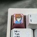 Close-up views of the artistic Ai Haibara Titanium Keycap, revealing the intricate anime design and luxurious metallic texture for mechanical keyboard.