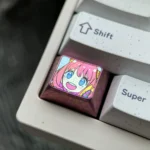 Iconic Anya Forger titanium keycap gallery, showcasing vibrant anime art on sleek, durable metal from multiple angles. A premium and playful design.