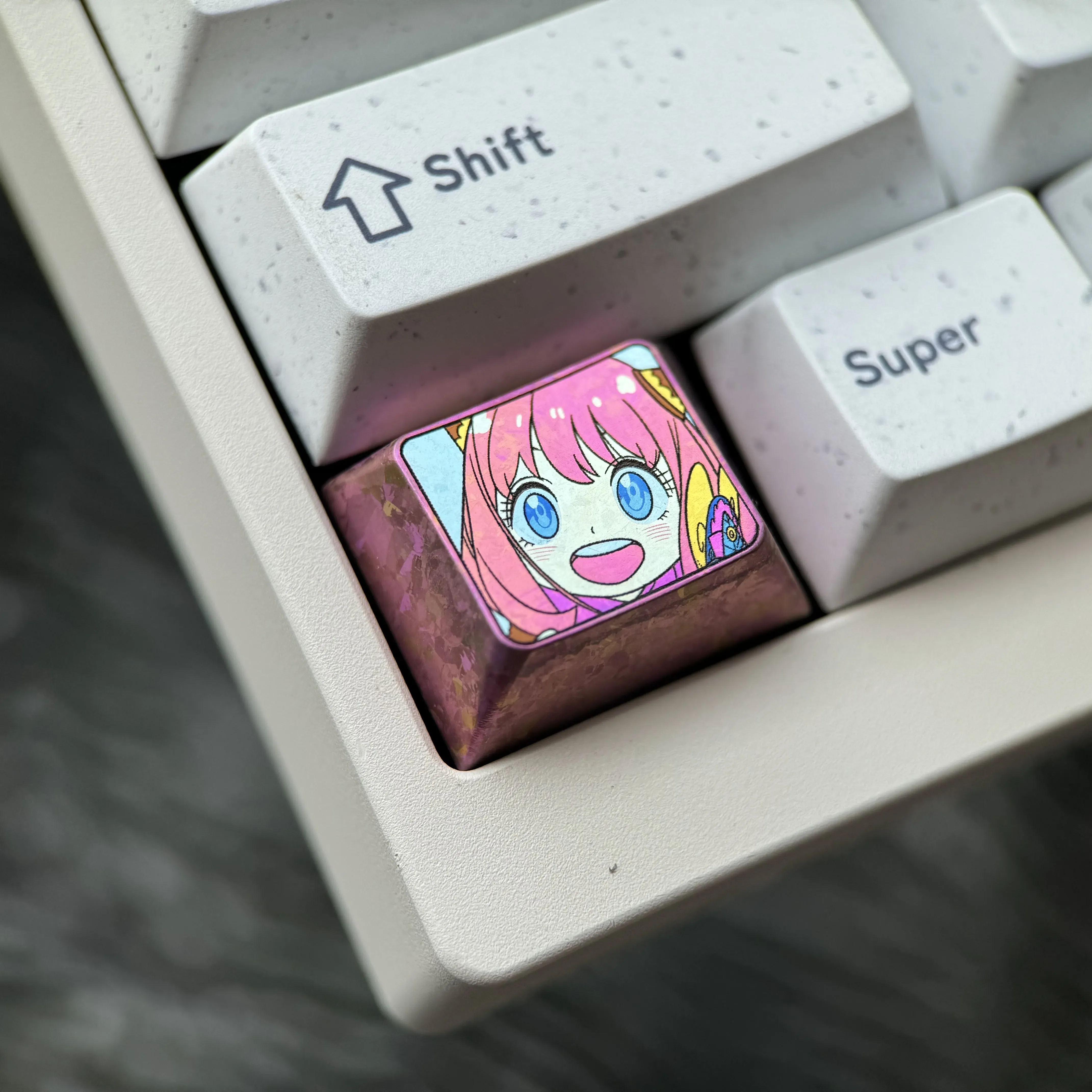 Gallery of the iconic Anya Forger titanium keycap, showcasing vibrant anime art on sleek, durable alloy from various angles, truly premium setup.