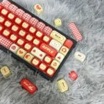 Artistic MOA profile Apple Keycaps Set from the Rustic Town Set, shown from various angles, featuring unique heartwarming pastoral apple and whimsical design.