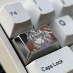 Close-up views of the Iconic Asuka Keycap from various angles, highlighting its bold anime art, metallic luster, and precision engraved details.