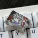 Multiple views of the Iconic Asuka keycap, showcasing its precision engraved design, bold anime art, and gleaming metallic finish.