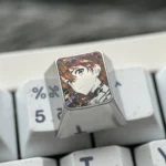 Frontal view of the precision-carved Asuka ESC keycap, showcasing its intricate anime character design and polished metallic luster, a premium design.