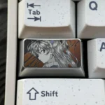 Artisan Asuka keycap inspired by Evangelion, highlighting precision-engraved metallic details and an intricate character portrait.
