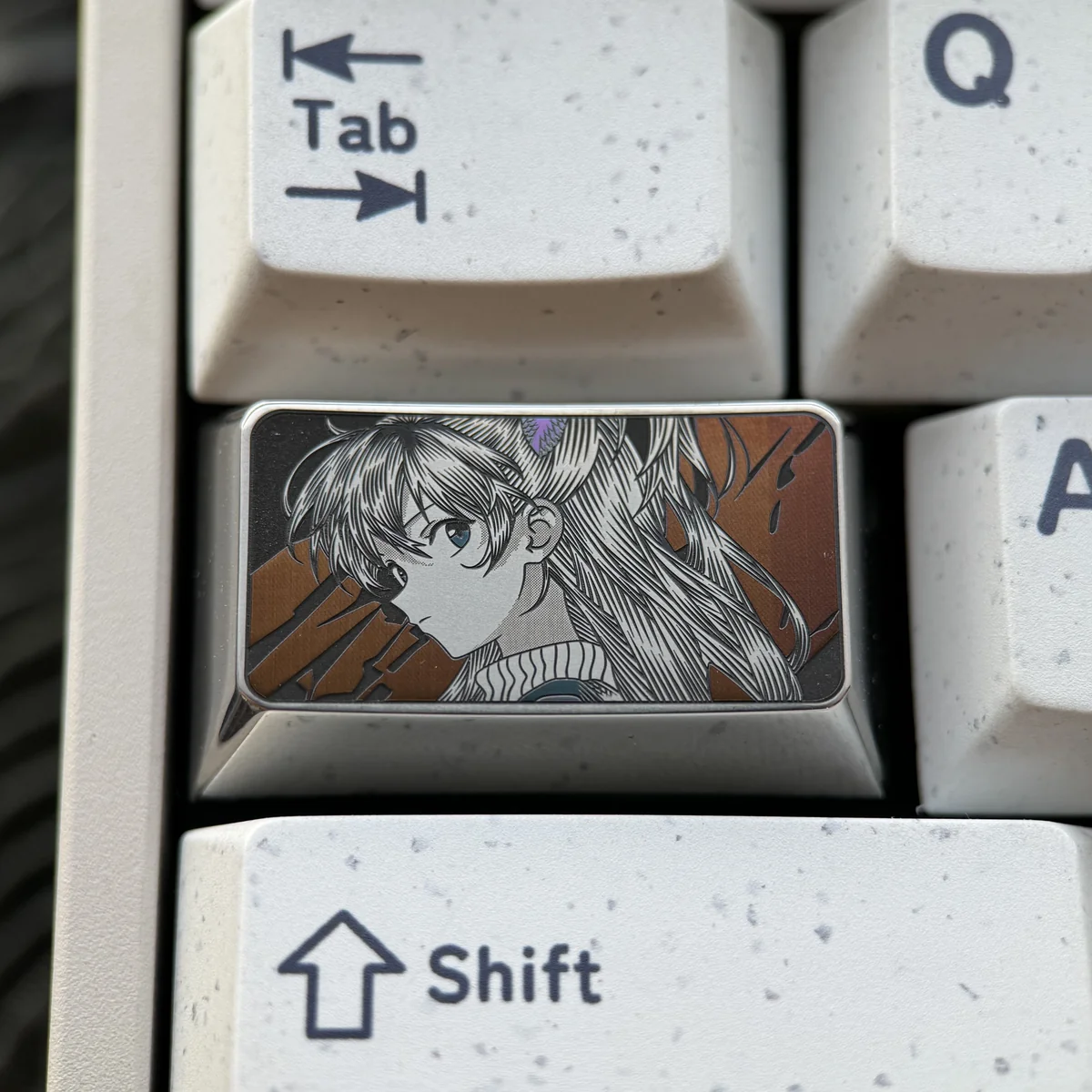 Asuka Keycap featuring precision-engraved Evangelion anime art, showcasing intricate metallic detail and a futuristic mech design.
