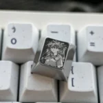 Vibrant Asuka titanium alloy keycaps, precision-engraved with intricate Evangelion character art, showcasing premium metallic sheen.