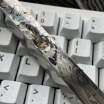 Close-up shots of the Asuka Titanium Keycap spacebar, highlighting its precision-engraved vibrant anime mecha art and durable titanium construction.