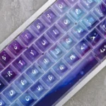 Ethereal Aurora Keycaps set, photographed from multiple angles, showcasing the captivating frosted translucency and vibrant light-diffusing aurora design.