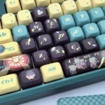 Aventurine FOA PBT Dye-Sub keycaps set artfully displayed, showcasing mystical green and shimmering gold flecks, emphasizing the ergonomic sculpted FOA profile design.