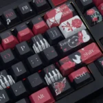 Ayn Keycap Set gallery: double-shot PBT keycaps with subtle side-printed character legends. Artistic, minimalist design viewed from various angles.