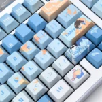 Exclusive Bai Qi PBT dye-sub keycaps, displaying elegant Love & Producer character motifs and a sophisticated cool palette from multiple angles.