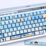 Exclusive Bai Qi PBT keycaps showcasing elegant Love & Producer character art in a sophisticated, cool-toned dye-sub set.