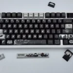 Premium DC Batfamily Batman keycaps set, featuring detailed sculpts from multiple angles, highlighting iconic dark designs and vibrant character accent.