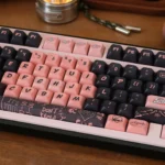 Vibrant collection of exclusive Black Pink PBT dye-sub keycaps set, revealing their bold black and pink motifs from diverse angles.