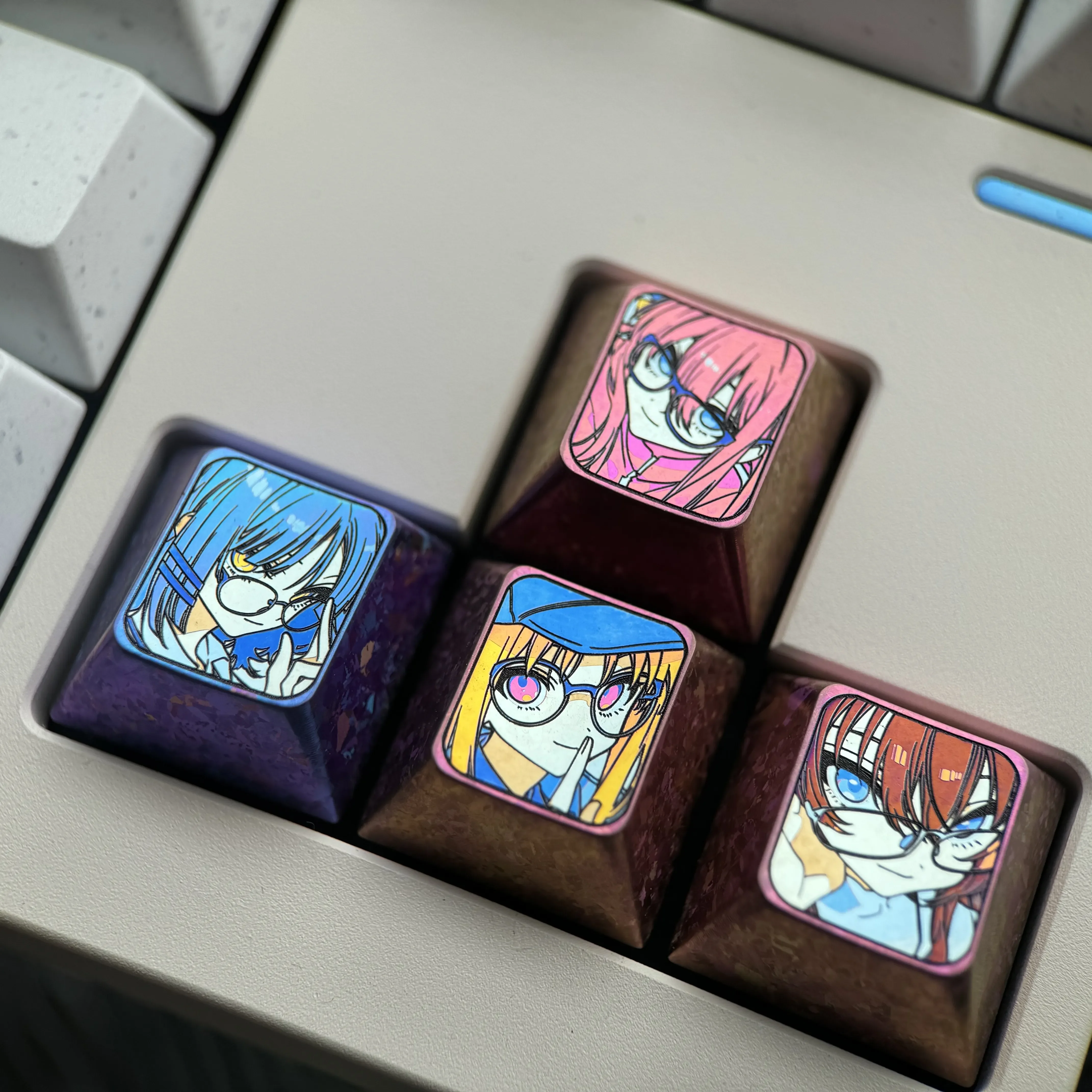 Artistic Premium Titanium Bocchi Keycaps set displaying vibrant anime directional keys and the iconic Hitori Gotoh glasses keycap.