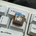 Vibrant Premium Titanium Bocchi Keycaps featuring anime character motifs, Hitori Gotoh glasses, and directional keys. High-quality artistic colored design.