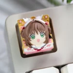 Handcrafted Cardcaptor Sakura resin keycap, with vibrant Sakura Kinomoto figurine and magical aesthetic for mechanical keyboards.