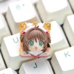 Exquisite handcrafted Cardcaptor Sakura keycap for mechanical keyboards, showcasing a vibrant Sakura Kinomoto figurine and detailed magical resin design.
