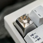 A gallery of the Cartethyia precision-engraved titanium anime ESC keycap, highlighting intricate pointillism design and polished titanium finish.