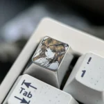 Gallery of the Cartethyia precision-engraved titanium anime ESC keycap, showcasing its intricate pointillism design from various artistic angles.