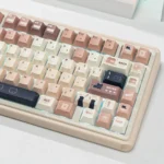 Collection of whimsical cat keycaps set, showcasing durable PBT dye-sub designs and charming feline art in a cozy coffee & cream theme.