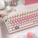 Close-up gallery of cat-themed PBT keycaps in gentle mint and blush tones, decorated with playful dye-sub kittens and sugary motifs.