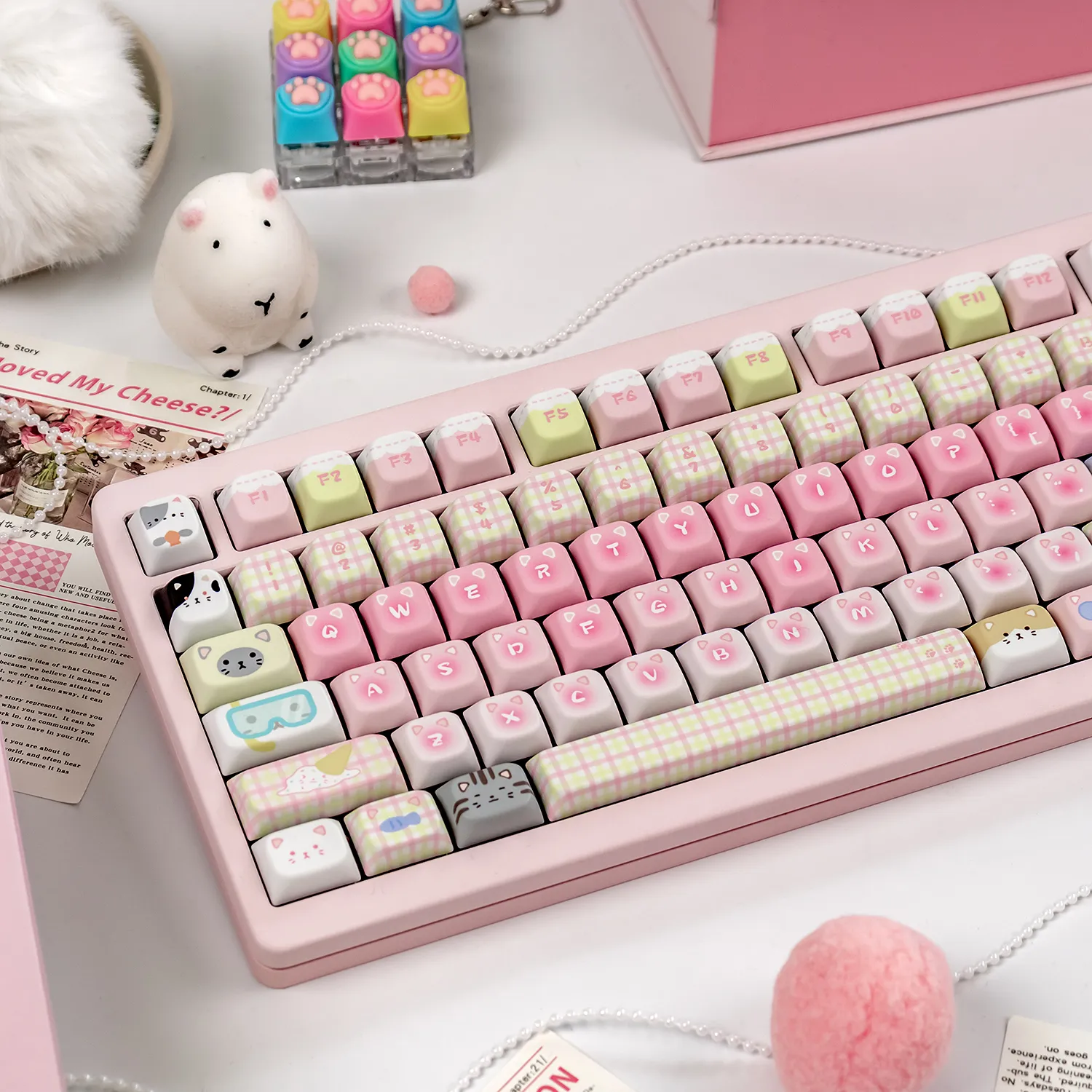Close-up gallery of cat-themed PBT keycaps in gentle mint and blush tones, decorated with playful dye-sub kittens and sugary motifs.