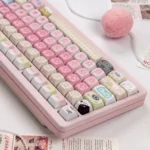 Aesthetic keyboard keycap gallery highlighting a mint-pink palette, whimsical cat icons, and candy-style patterns on durable PBT caps.