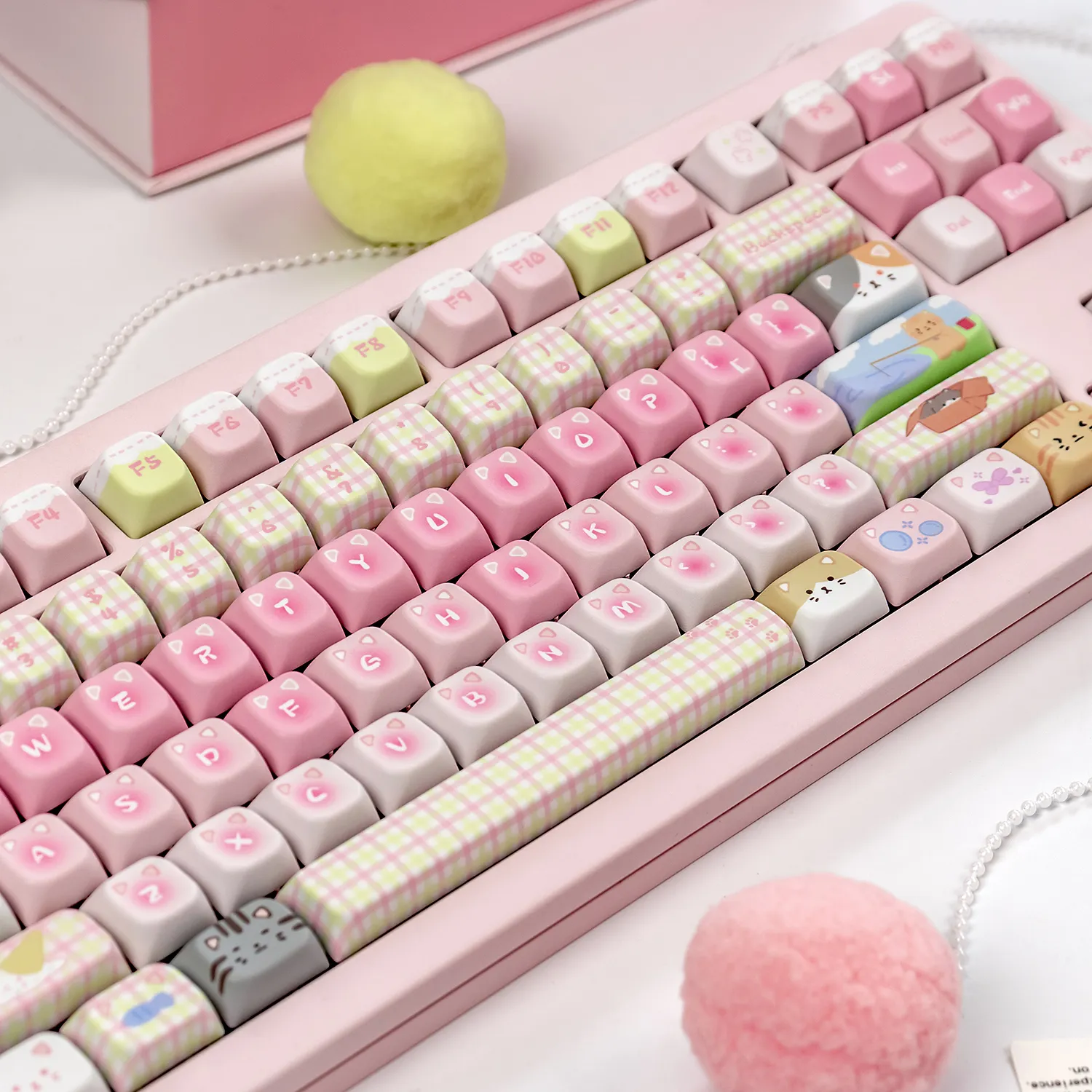 Soft pastel PBT keycap collection presented in a gallery, decorated with mint-and-pink cat designs and light candy-inspired embellishments.
