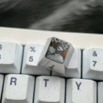 Detailed views of the Chainsaw Man Denji titanium keycap, revealing its vibrant precision-engraved anime character art and premium metallic finish.