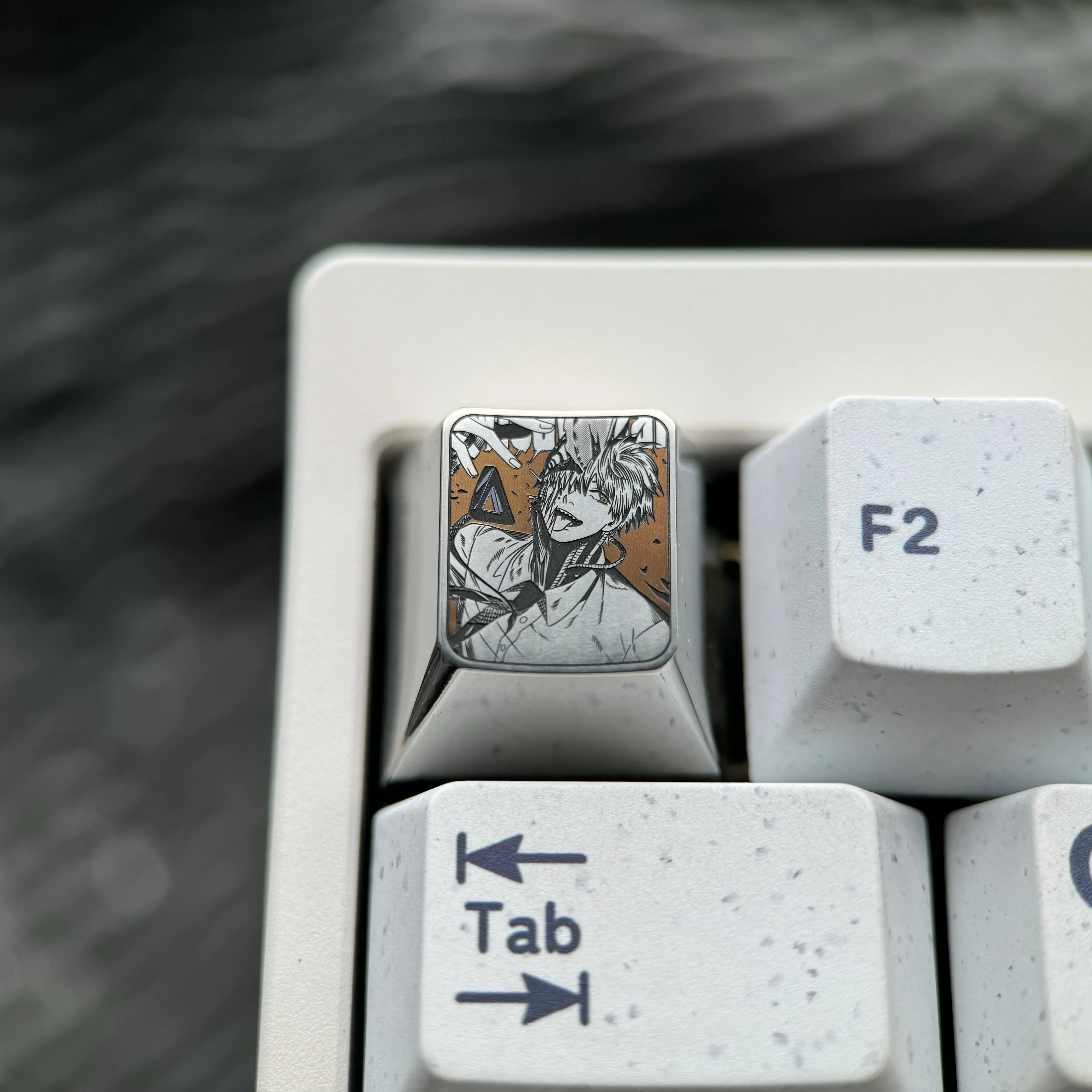 Experience premium craftsmanship: a Chainsaw Man Denji titanium keycap, showcasing vibrant, precision-engraved anime art as an ESC art piece.