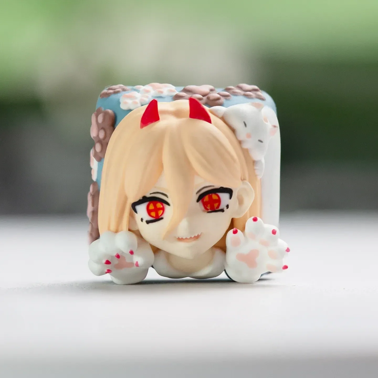Dynamic handcrafted Chainsaw Man Power keycap, a custom resin mechanical keyboard accessory, shown from various angles. Highlights meticulous design.
