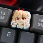 Handcrafted resin Chainsaw Man Power keycap for mechanical keyboards, showcasing a dynamic and cute anime character with vibrant colors.