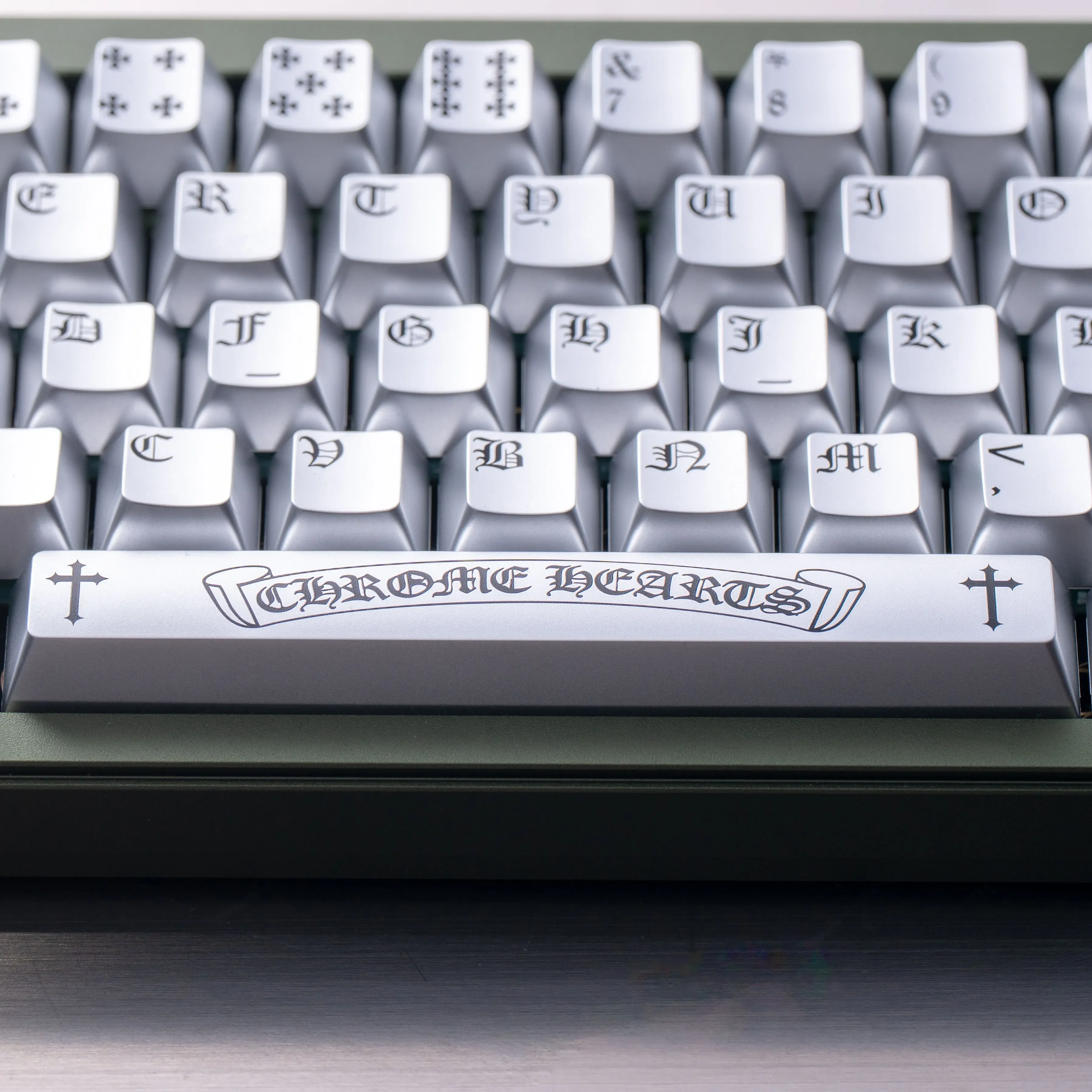 Multiple angles of the Chrome Hearts Keycap Set, showcasing its distressed chrome finish, iconic rebel style, and magnetic switch.