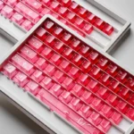 Playful luminous cinnabar pink keycaps set reveal their transparent gradient beauty from multiple angles, highlighting their unique charm.