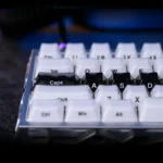 Crystal Jelly Sword Keycap set in translucent black crystal, shown from various angles, revealing its glowing jelly texture and side-engraved sword.