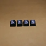 A 4-piece set of black translucent CSGO weapon switch keycaps, featuring iconic weapon silhouettes illuminated for a playful, tactical gaming setup.