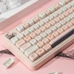 Close-up of Cupid Keycap Set highlighting intricate angelic cherub and heart designs on durable PBT dye-sublimated keys in a dreamy black and pink palette.