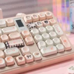 Dreamy black and pink Cupid Keycap Set displayed from an artistic angle, featuring playful angelic cherubs and hearts on high-quality PBT dye-sublimation.